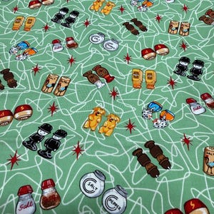 May include: A light green fabric with a retro design featuring illustrations of salt and pepper shakers, hot dogs, mustard bottles, and cartoon figures. The design includes white squiggly lines and red starbursts.