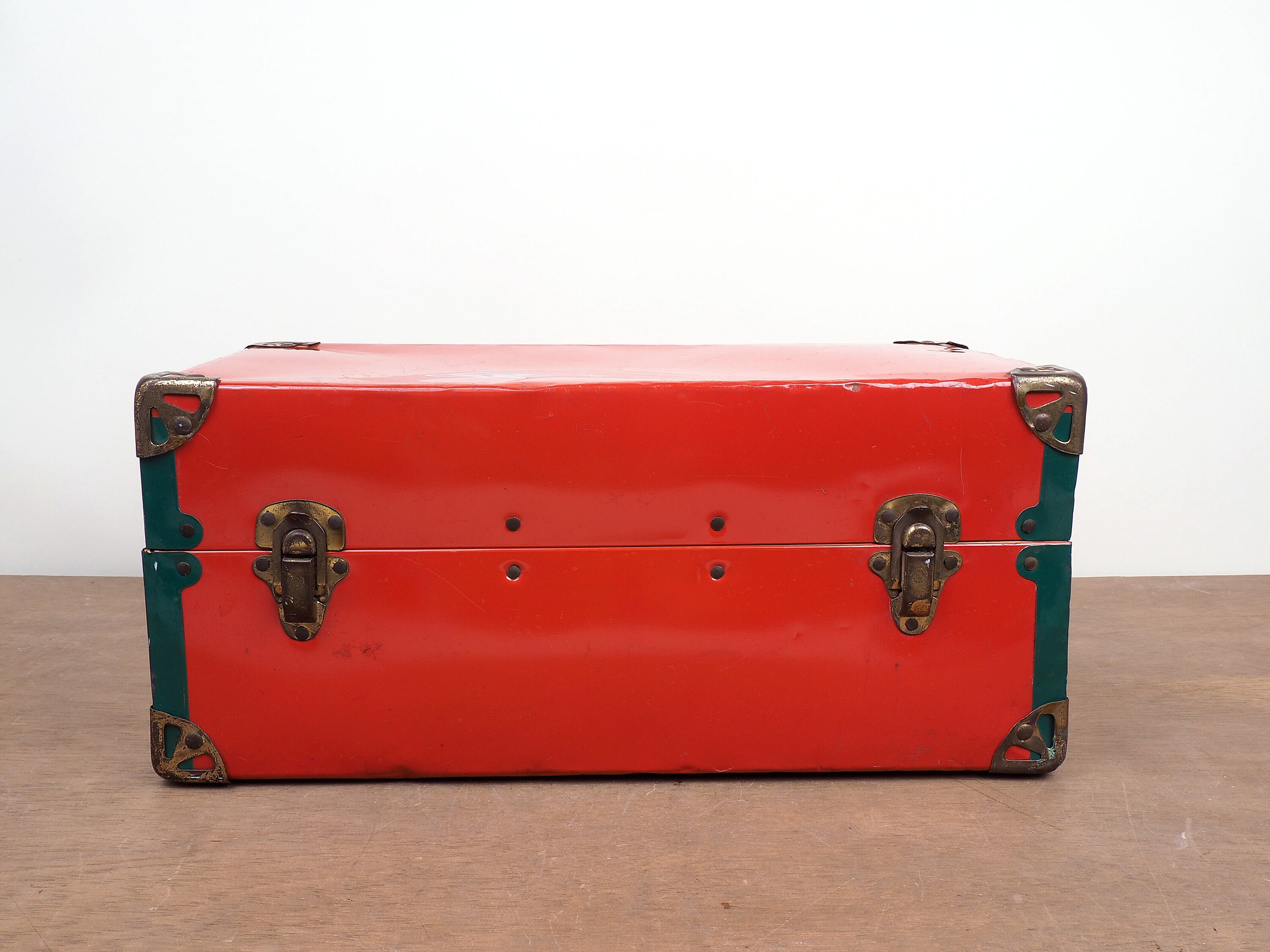Old, green, vintage retro suitcase with leather handle and metal