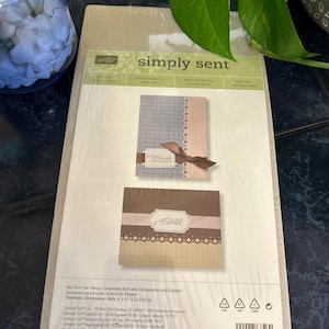May include: A Stampin' Up! Simply Sent card kit in a clear plastic package. The packaging displays two card designs, one with a brown ribbon and the text Cherish, and another with the text You're Sweet. The dimensions are listed as 6 inches by 9 inches.