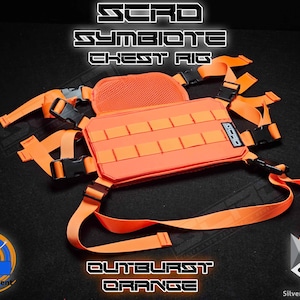 May include: A bright orange chest rig featuring a rectangular panel with horizontal webbing straps, adjustable nylon webbing straps with black plastic buckles, and a mesh back pad. The text SCRD SYMBIOTE CHEST RIG and OUTBURST ORANGE is visible.