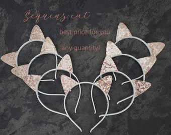 May include: A set of eight gold sequin cat ear headbands. The headbands are white and have pink sequin cat ears. The headbands are arranged in a heart shape on a gray background. The text "Sequins cat" and "best price for you any quantity!" is written in pink on the background.