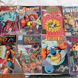May include: A collection of 10 comic books featuring various superheroes and characters. The comic books are in various colors, including red, blue, green, yellow, and black. The comic books are arranged in two rows, with five comic books in each row. The comic books are all in good condition and have no visible damage.