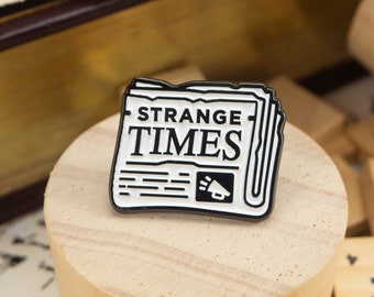 Strange Times Chronicle Enamel Pin – Newspaper print | Minimalist Pins | Monochrome Design | Black and White Pins