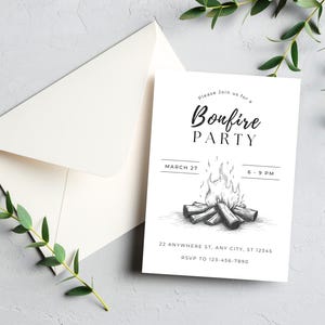 May include: A white invitation card with the text "Bonfire PARTY" and event details, including the date, time, and RSVP information. An off-white envelope is visible behind the card. The invitation features a bonfire illustration.