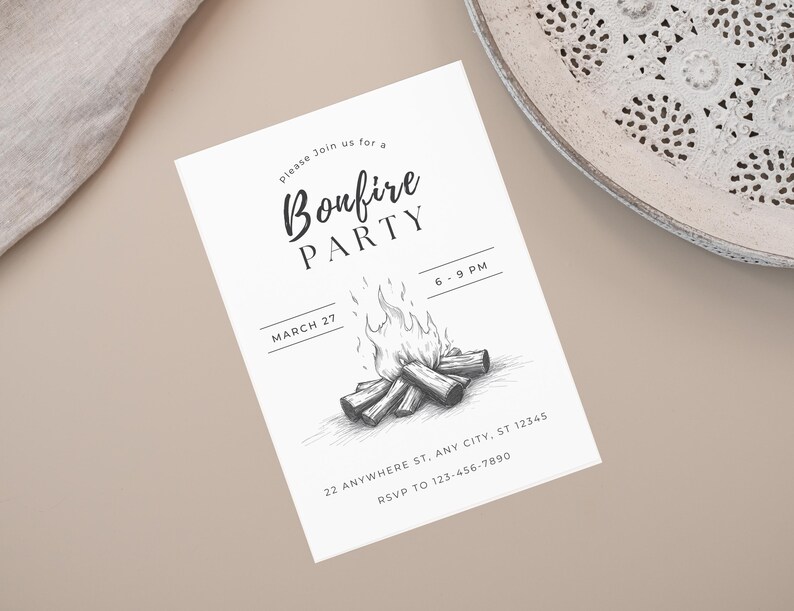 May include: A white invitation card with the text "Bonfire Party" in a script font. The card features a black and white illustration of a bonfire and the date March 27. The card also includes the time, address, and RSVP information.