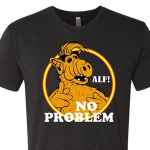 May include: A black t-shirt with a graphic of ALF, the alien from the 80s TV show, with the text "ALF! NO PROBLEM".