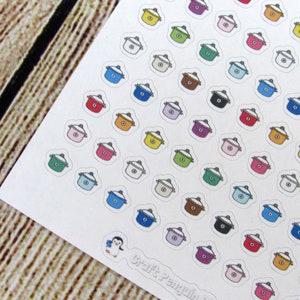 May include: A sheet of colorful pot stickers. The stickers are in various colors, including red, orange, yellow, green, blue, purple, pink, and white. The stickers are arranged in a grid pattern on a white background.
