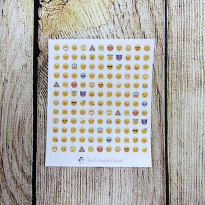 May include: A sheet of white paper with a grid of 100 yellow emoji stickers. The emojis include smiling faces, winking faces, hearts, sunglasses, and more. The sheet is labeled "Craft Penguin Press".
