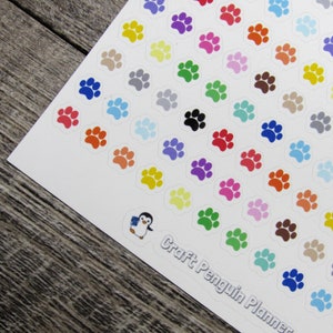May include: A sheet of colorful paw print stickers with a penguin logo and the text "Craft Penguin Planner".