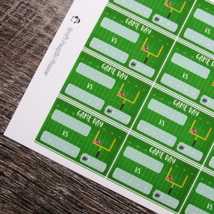 May include: Printable game day scorecards with a green football field background and a football goal post with a football. The text "GAME DAY" is printed on each card with spaces to write in the teams playing and the score.