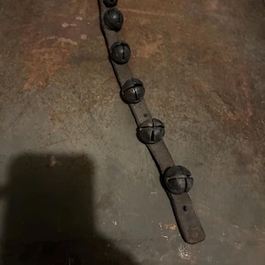 Antique set of five sleigh bells, jingle bells, horse bells attached to leather strap. Beautiful sound