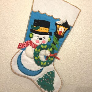 Vintage UNUSED handmade completed felt Bucilla Christmas stocking from a 1981 kit called Frosty’s wreath. Features a wreath holding snowman.