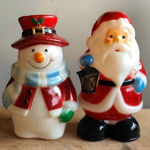 Vintage hard plastic blow mold snowman and santa clause christmas light decoration 8" tall. Add a light to the bottom and they will shine.