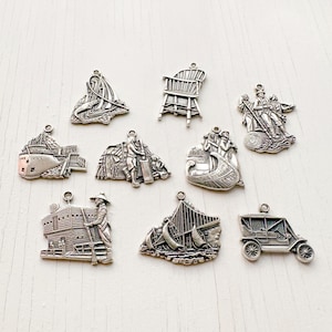 May include: A collection of ten silver charms featuring various designs, including a boat, a chair, a building, and a car. The charms are all detailed and intricate, and they would make a great addition to any charm bracelet.