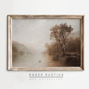 The image is a framed painting depicting a serene landscape with a lake, trees, and mountains in the background.