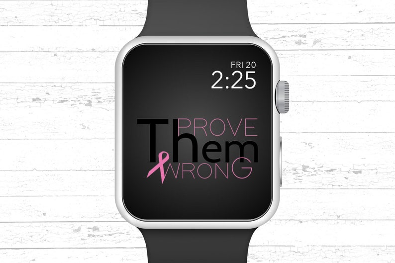 May include: A black and silver Apple Watch with a black band. The watch face displays the time "2:25" and the date "FRI 20". The text "PROVE THEM WRONG" is displayed on the watch face with a pink ribbon.