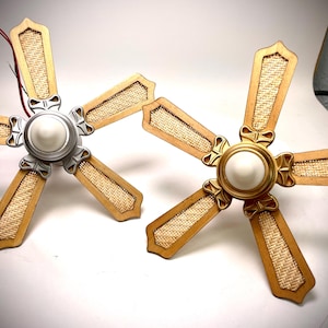 May include: Two ceiling fan blades, each with five blades. One fan has silver accents, the other gold. The blades are light brown with a woven texture. The fans are on a white surface. The blades measure approximately 76 cm.