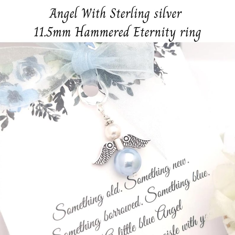 May include: A sterling silver angel charm with a blue pearl body and silver wings. The charm is attached to a ring and is accompanied by a light blue ribbon and text that reads "Something old. Something new. Something borrowed. Something blue."