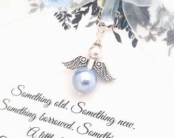 May include: A silver angel charm with a light blue pearl body and pearl head, adorned with detailed wings. The charm hangs from a silver ring. Text on the white background reads "Something old. Something new. Something borrowed. Something blue."