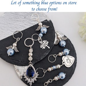 May include: Several keychains with blue pearl beads, silver accents, and charms, including angel wings, a tree, and a heart. The text "Lot of something blue options on store to choose from!" is visible.