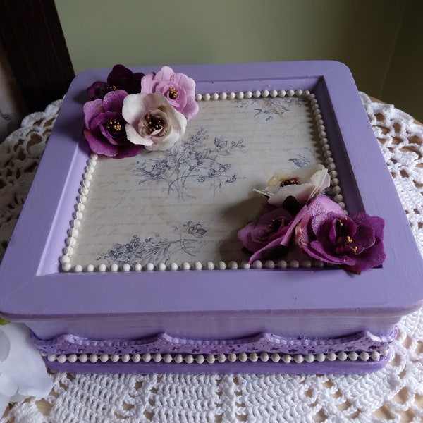 Purple color with elegant flowers. Small jewelry box but big on style. Resin detains and white beading give it tons of style.