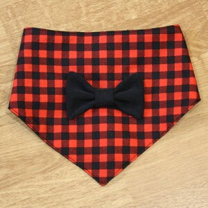 May include: Red and black checked bandana with a black bow tie.