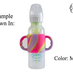 May include: A clear baby bottle with a silicone handle in a marble pattern of pink, purple, and yellow. The bottle has a Dr. Brown's label.