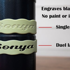 May include: Two close-up images of a black cylinder with a light green band around it. The band has the name "Sonya" engraved on it. The top image shows a single layer of engraving, while the bottom image shows a duel layer of engraving. The text "Engraves black! No paint or ink!" is visible above the images. The text "Single layer" is visible to the right of the top image. The text "Duel layer" is visible to the right of the bottom image.