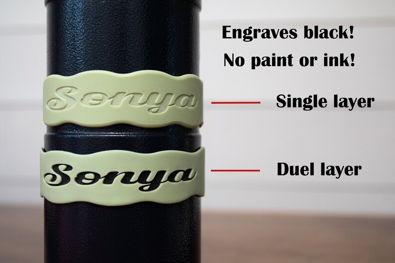 May include: Two close-up images of a black cylinder with a light green band around it. The band has the name "Sonya" engraved on it. The top image shows a single layer of engraving, while the bottom image shows a duel layer of engraving. The text "Engraves black! No paint or ink!" is visible above the images. The text "Single layer" is visible to the right of the top image. The text "Duel layer" is visible to the right of the bottom image.