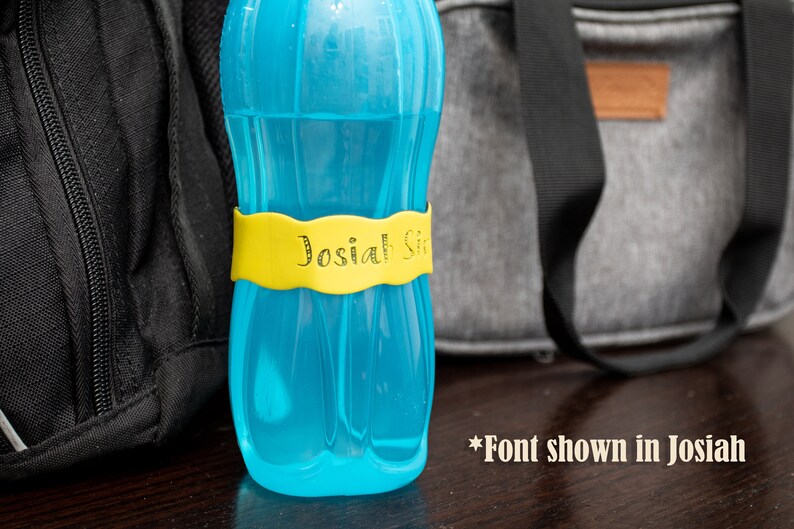 May include: A blue water bottle with a yellow label that says "Josiah Sr." in a decorative font.