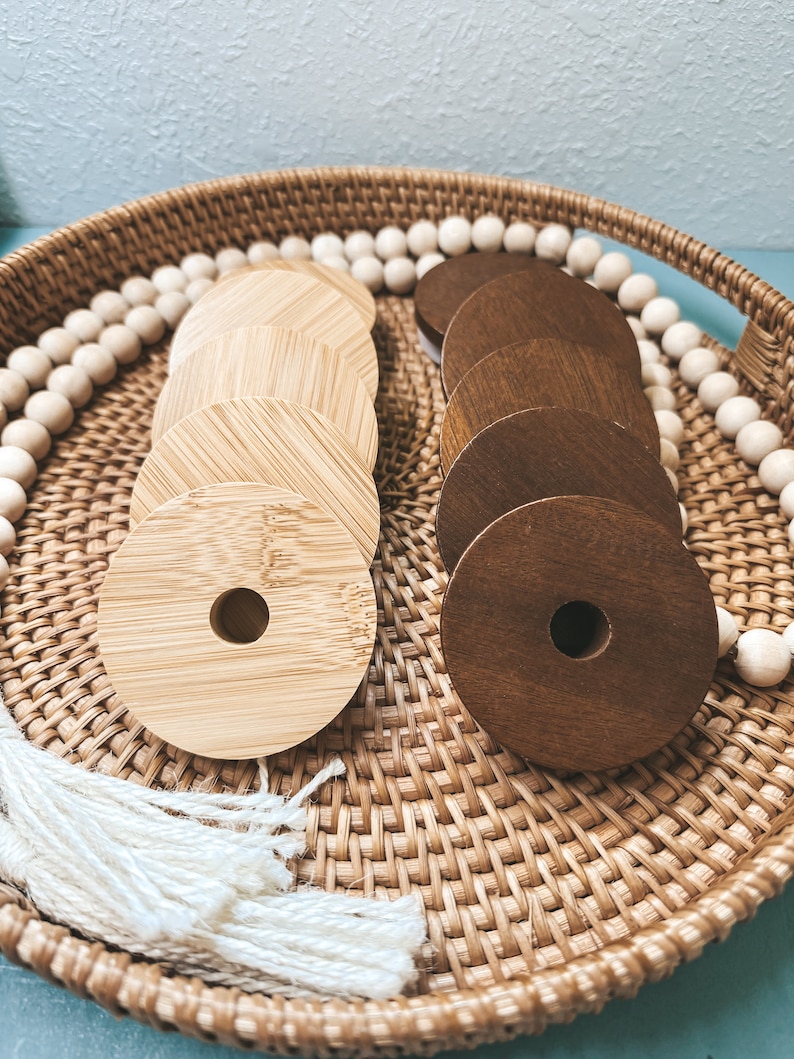 May include: A wicker basket filled with wooden rings, some are light brown and some are dark brown. The basket is lined with white beads.