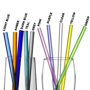 May include: A collection of colorful glass straws in a clear glass. The straws are in various colors, including light blue, amber, dark blue, teal, grey, pink, purple, clear, yellow, and green. Text labels identify each color.