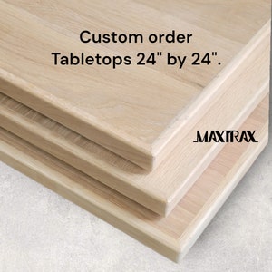 May include: Three unfinished wood tabletops stacked on top of each other. The tabletops are 24 inches by 24 inches. The text "Custom order Tabletops 24" by 24"." and the logo "MAXTRAX" are visible on the tabletops.