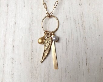 Charm necklace with tiny silver gray freshwater pearl and 14k gold-filled tiny wing, tear drop and bar