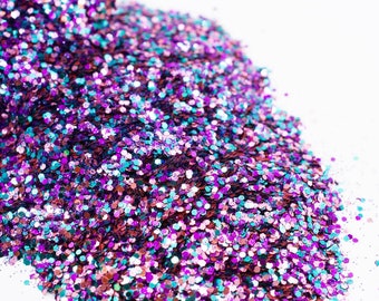 May include: A pile of iridescent glitter with a mix of purple, pink, blue, and green colors.