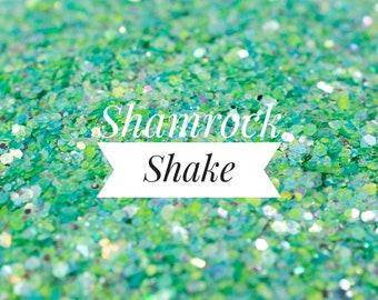 May include: Green glitter with a white banner that says "Shamrock Shake".