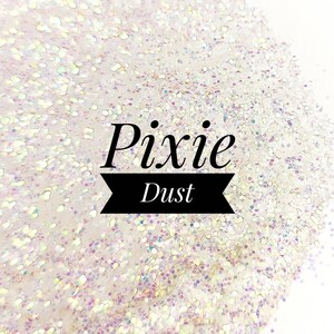 May include: Close-up of iridescent glitter, with the words "Pixie Dust" in black script. The glitter is a mix of white and pastel colors, creating a shimmering effect. The background is white.