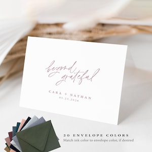 May include: A white card with the words "beyond grateful" in cursive script, along with the names "CARA + NATHAN" and the date "05.23.2026". Below the card are several colored envelopes. The text "20 ENVELOPE COLORS" is also visible.
