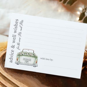 May include: White advice and well wishes card for the new Mr. and Mrs. The card features a watercolor illustration of a vintage car decorated with flowers. The text "advice & well wishes" and "with love by:" are printed on the card.