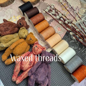 May include: An assortment of colorful waxed threads in various shades of brown, orange, and cream, alongside several handmade teddy bears. The image also includes pussy willow branches and the text "Waxed threads".