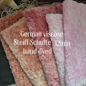 May include: A collection of hand-dyed German viscose Steiff Schulte fabric in shades of pink, rose, and brown. The fabric is 12mm thick and has a soft, plush texture. The text "German viscose Steiff Schulte 12mm hand dyed" is visible.
