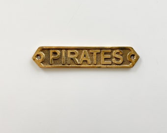 Vintage brass pirates wall sign