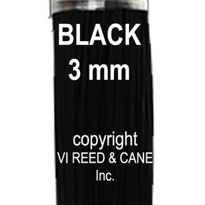 May include: A bundle of black 3 mm floral wire. The wire is wrapped in a clear plastic band. The text "BLACK 3 mm" is printed on the band. The text "copyright VI REED & CANE Inc." is printed below the band.