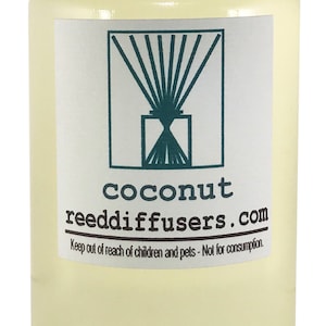 May include: A clear glass bottle with a white cap filled with a light yellow liquid. The label reads "coconut reeddiffusers.com" and includes a stylized image of a reed diffuser. The text "Keep out of reach of children and pets - Not for consumption." is also on the label.