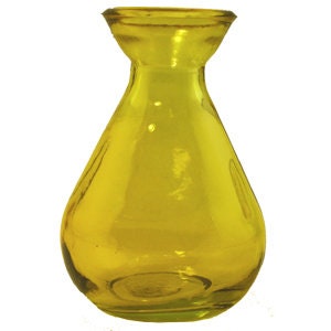 May include: A small, yellow glass vase with a rounded body and a narrow neck.