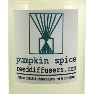May include: A clear glass bottle with a white cap filled with a light yellow liquid. The label reads "pumpkin spice reeddiffusers.com" and "Keep out of reach of children and pets - Not for consumption."
