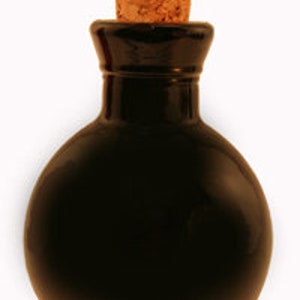 May include: A small, round, black glass bottle with a cork stopper.