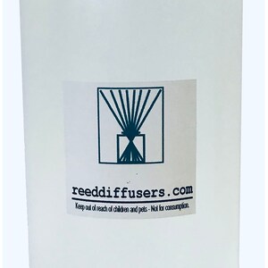 May include: A clear plastic bottle with a white cap. The bottle has a label with the text "reeddiffusers.com" and the words "Keep out of reach of children and pets - Not for consumption."