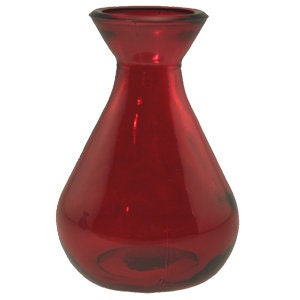 May include: A small, red glass vase with a rounded body and a flared opening.