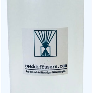 May include: A clear plastic bottle with a white cap. The bottle has a label with the text "reeddiffusers.com" and the words "Keep out of reach of children and pets - Not for consumption."